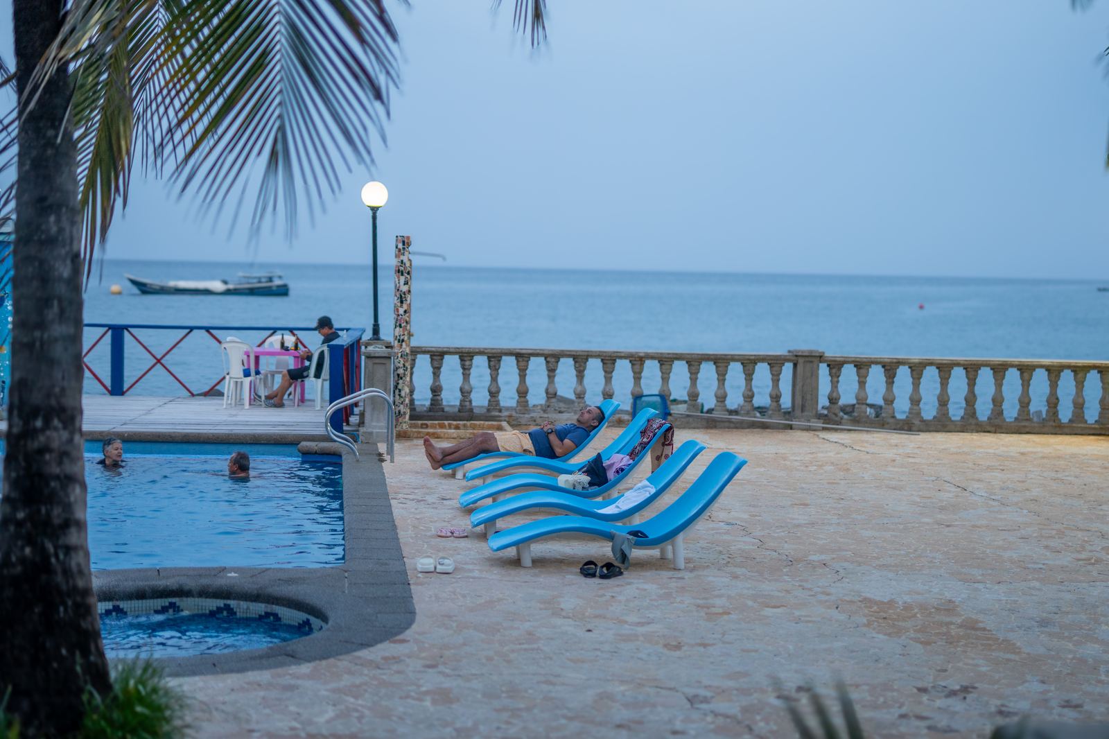 Loungers on the coral stone terrace by the sea