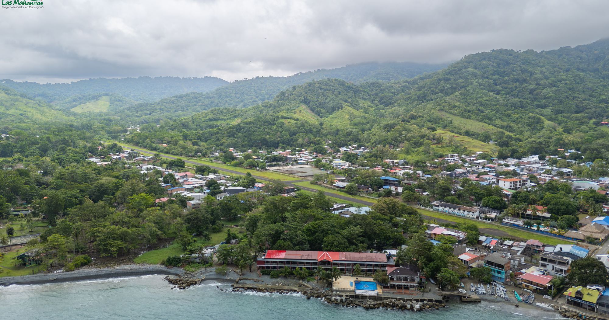 Capurganá from the air, with the airstrip, the town and the hotel by the water